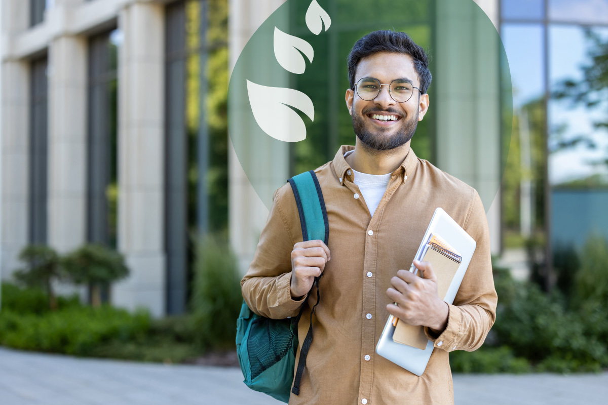  A smiling man wearing glasses, a brown shirt, and a backpack, stands outdoors holding a laptop and notebooks. A building and greenery are in the background. A translucent green overlay with white leaves is in the top right.