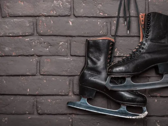 Black ice skates hanging up.