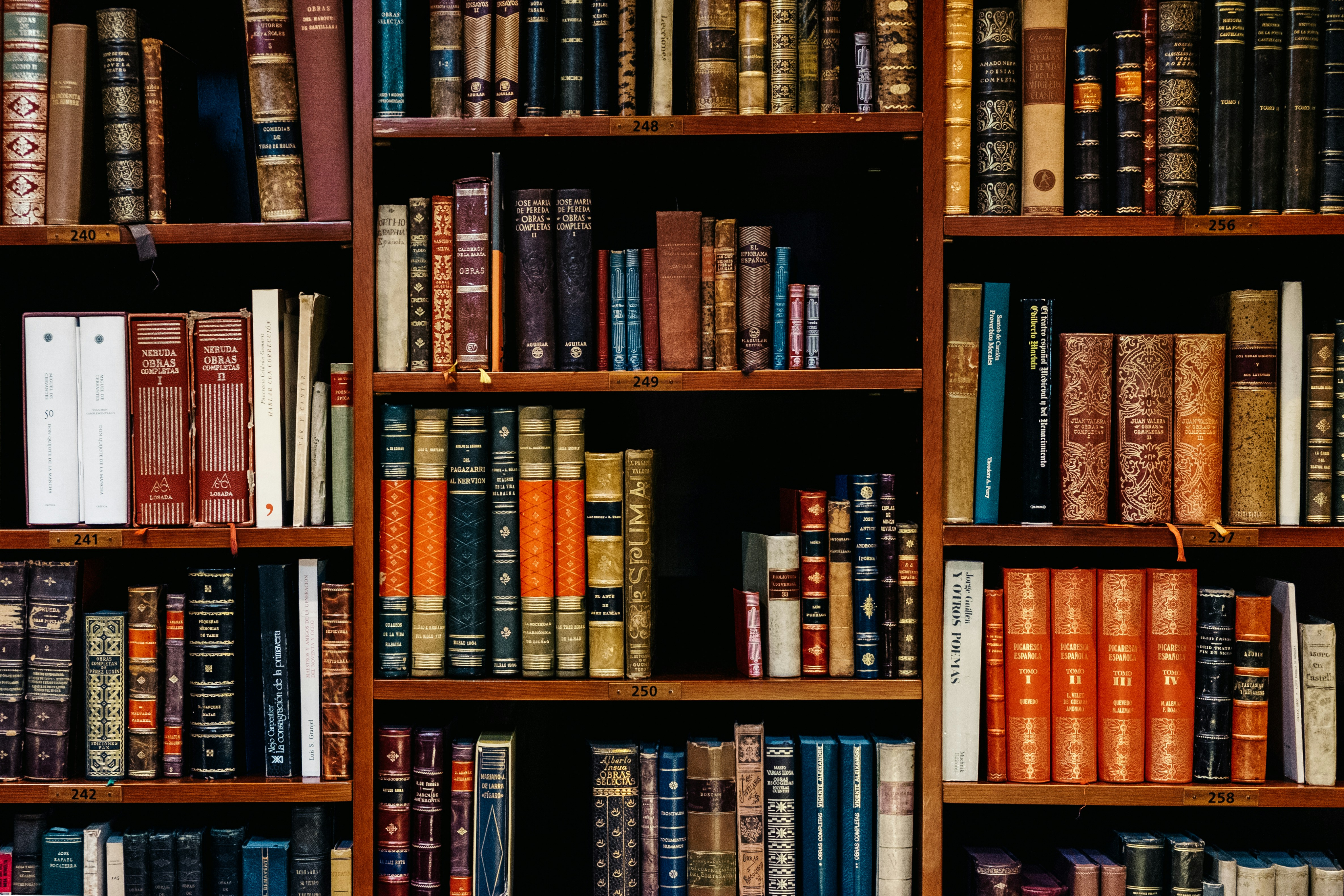 A photograph of lots of old books on a bookshelf.