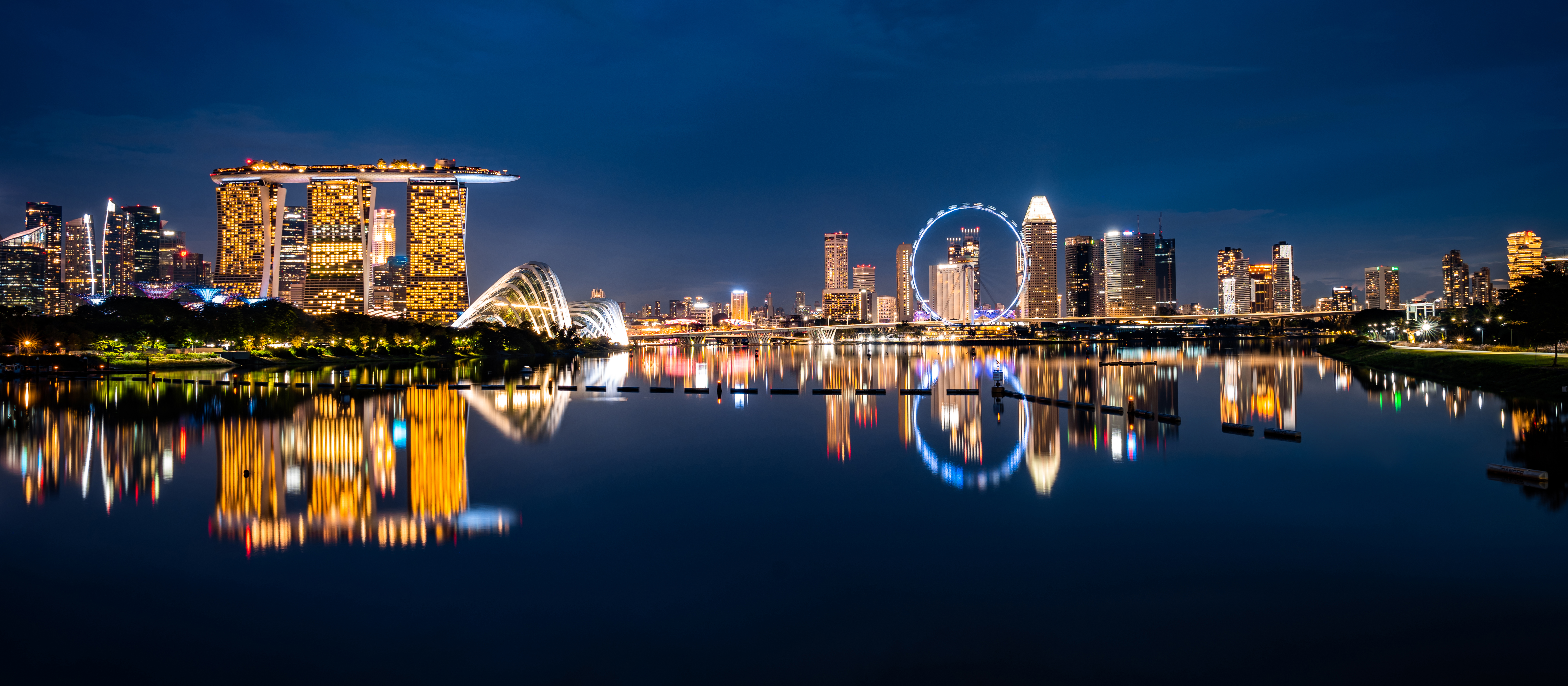Singapore skyline at night with Marina Bay Sands and city lights reflected in the water