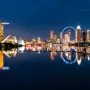 Singapore skyline at night with Marina Bay Sands and city lights reflected in the water