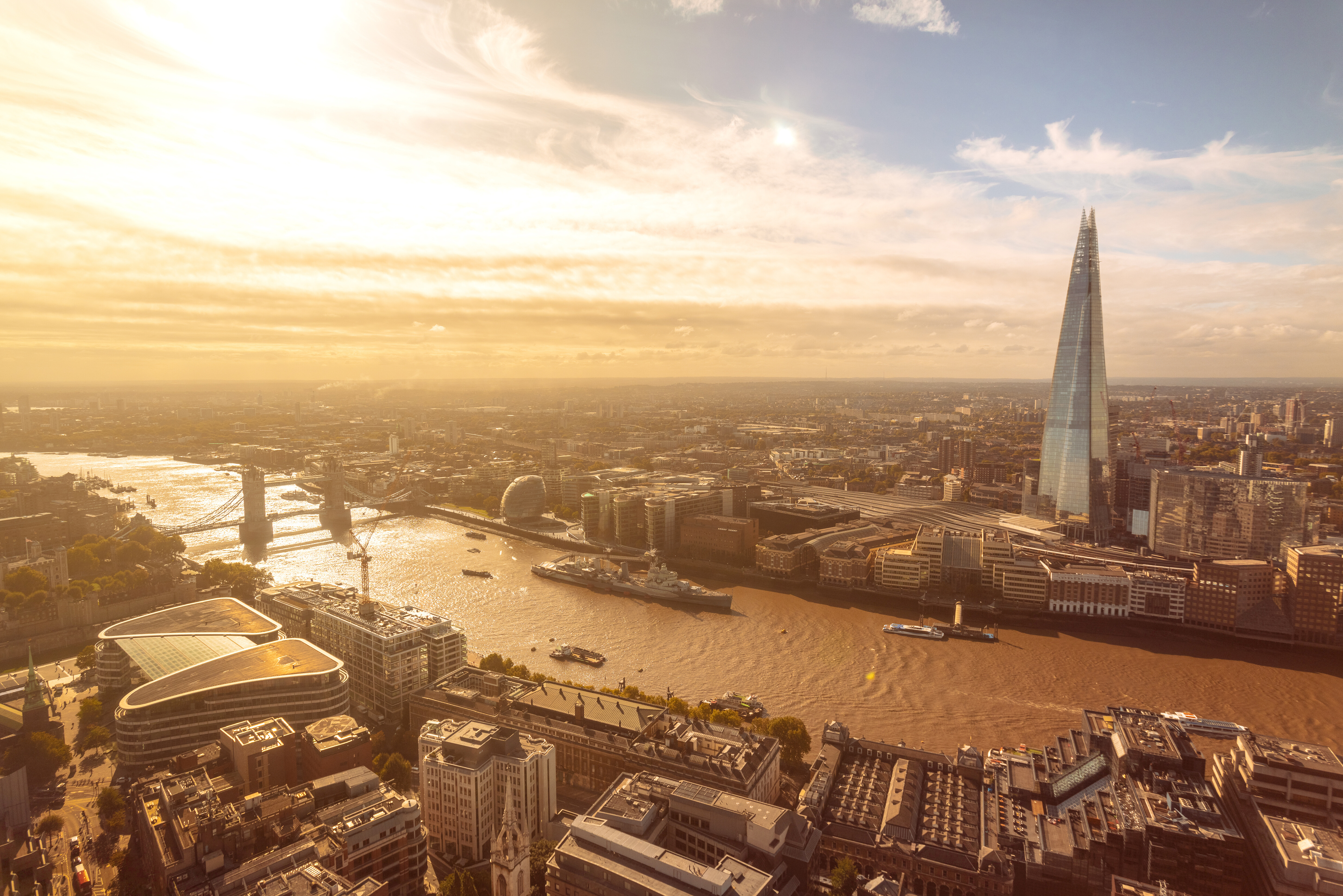 Golden hour skyline of London featuring the Shard and River Thames