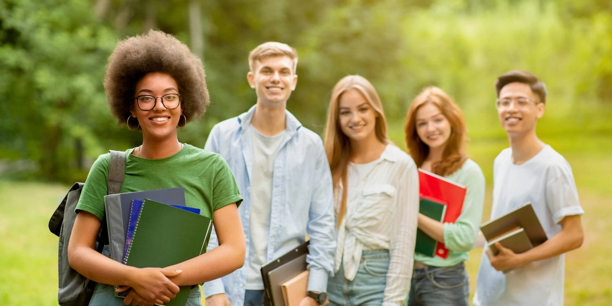 GCSE Level students in a row smiling towards the camera. 