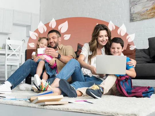 A family with two young children learning together at home, enjoying the flexibility of online education.