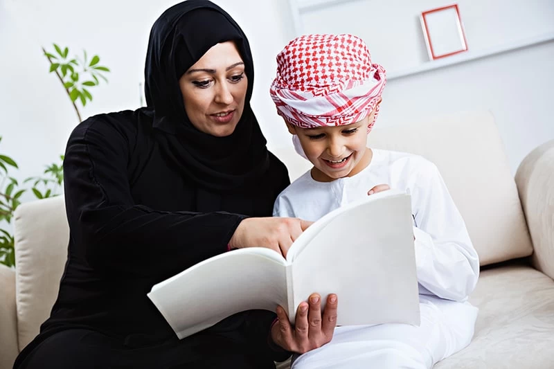 Mother supporting her son’s learning at home in UAE, showing the benefits of parent-led education with structure