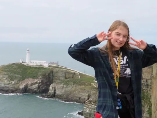 Wolsey Hall Oxford student, Lily, on a cliff.