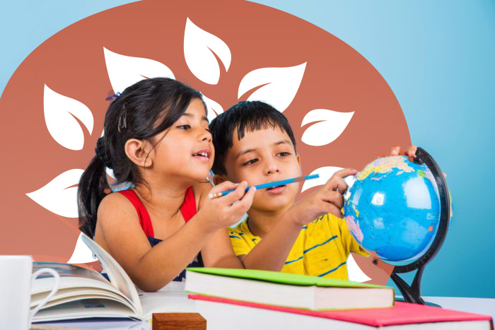 Young boy and girl looking at a globe and pointing out locations, surrounded by books