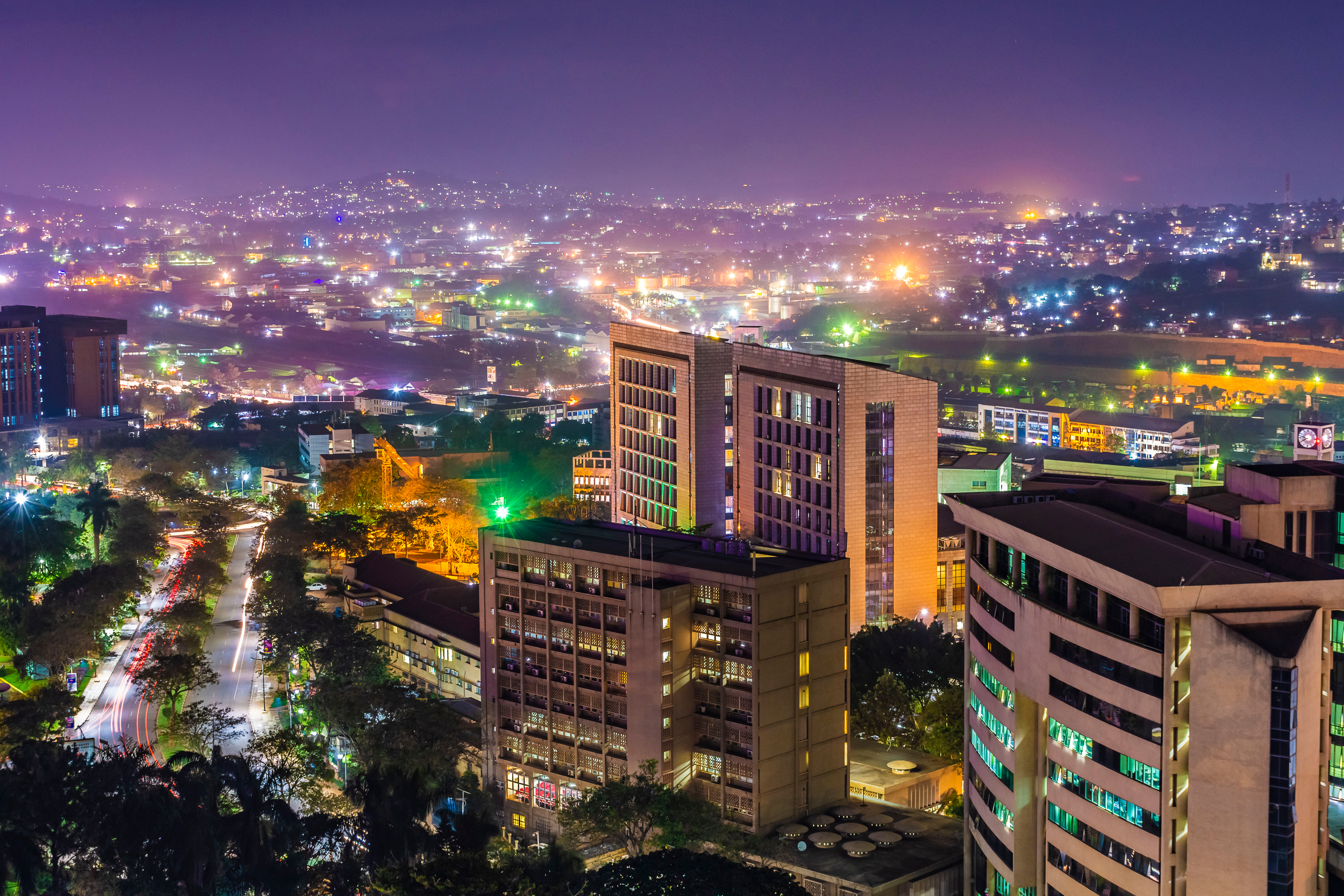 Night-time cityscape of Kampala with illuminated buildings and streets
