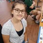 WHO student, Ruby, smiling and looking at the camera.