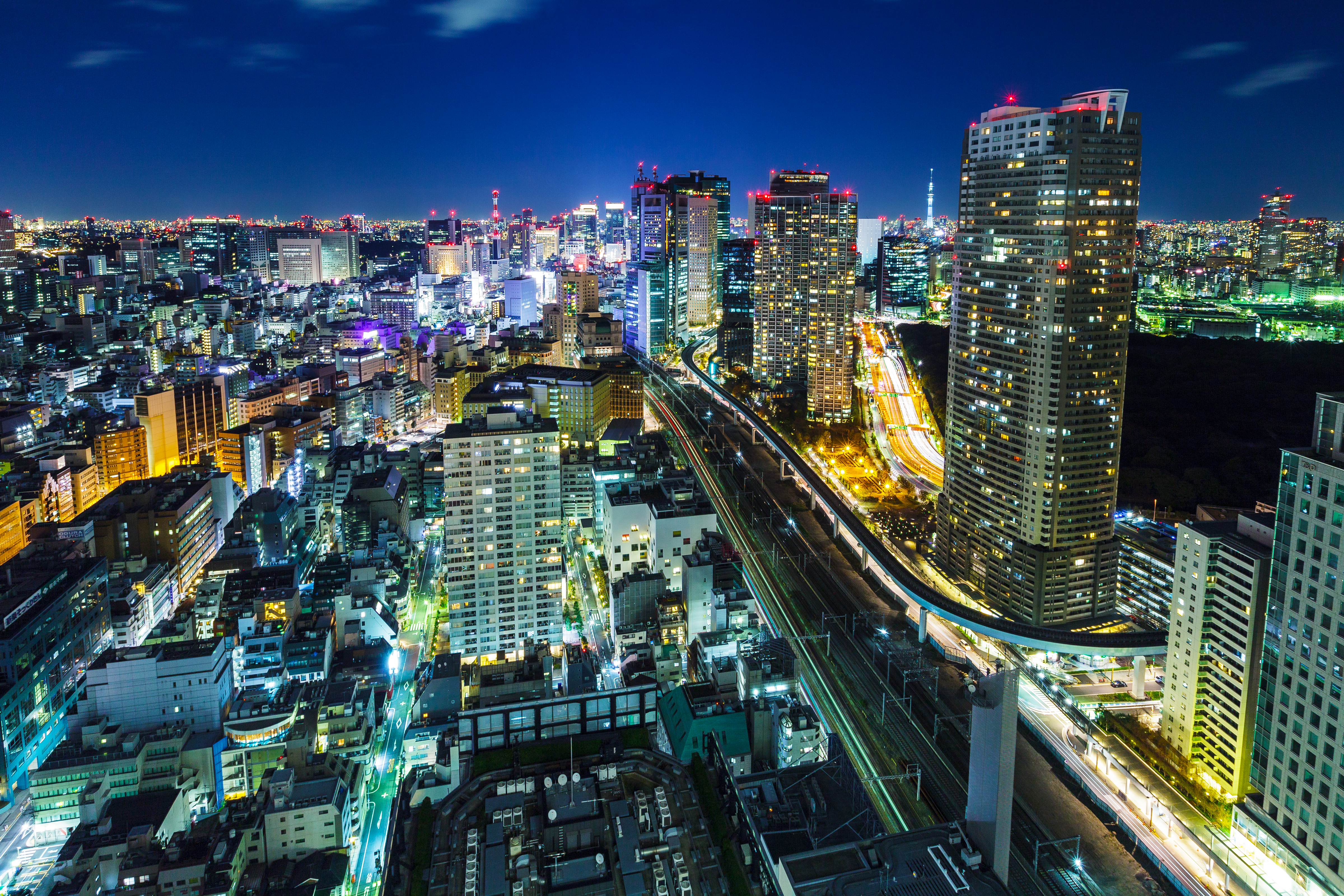 Tokyo city lights and high-rise buildings at night with visible expressway and skyline
