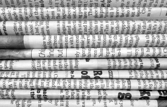 A stack of folded newspapers. 