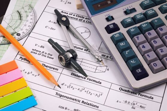 A calculator, and compass used to solve maths problems. 