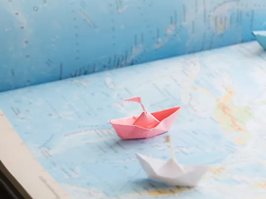 Paper boats on a map.