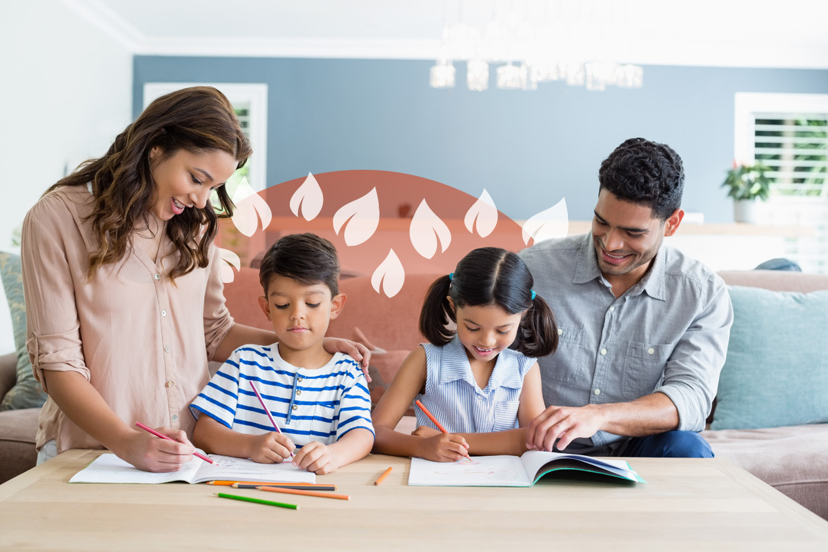 Two parents supporting their young children with schoolwork around a living room table.