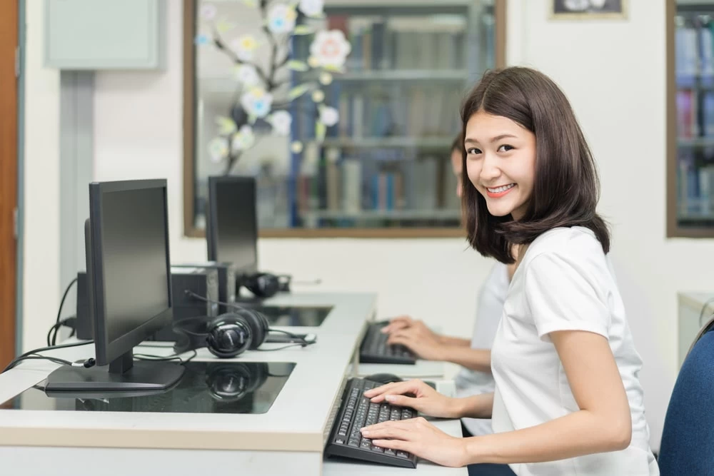 GCSE Level student using a computer for her studies. 