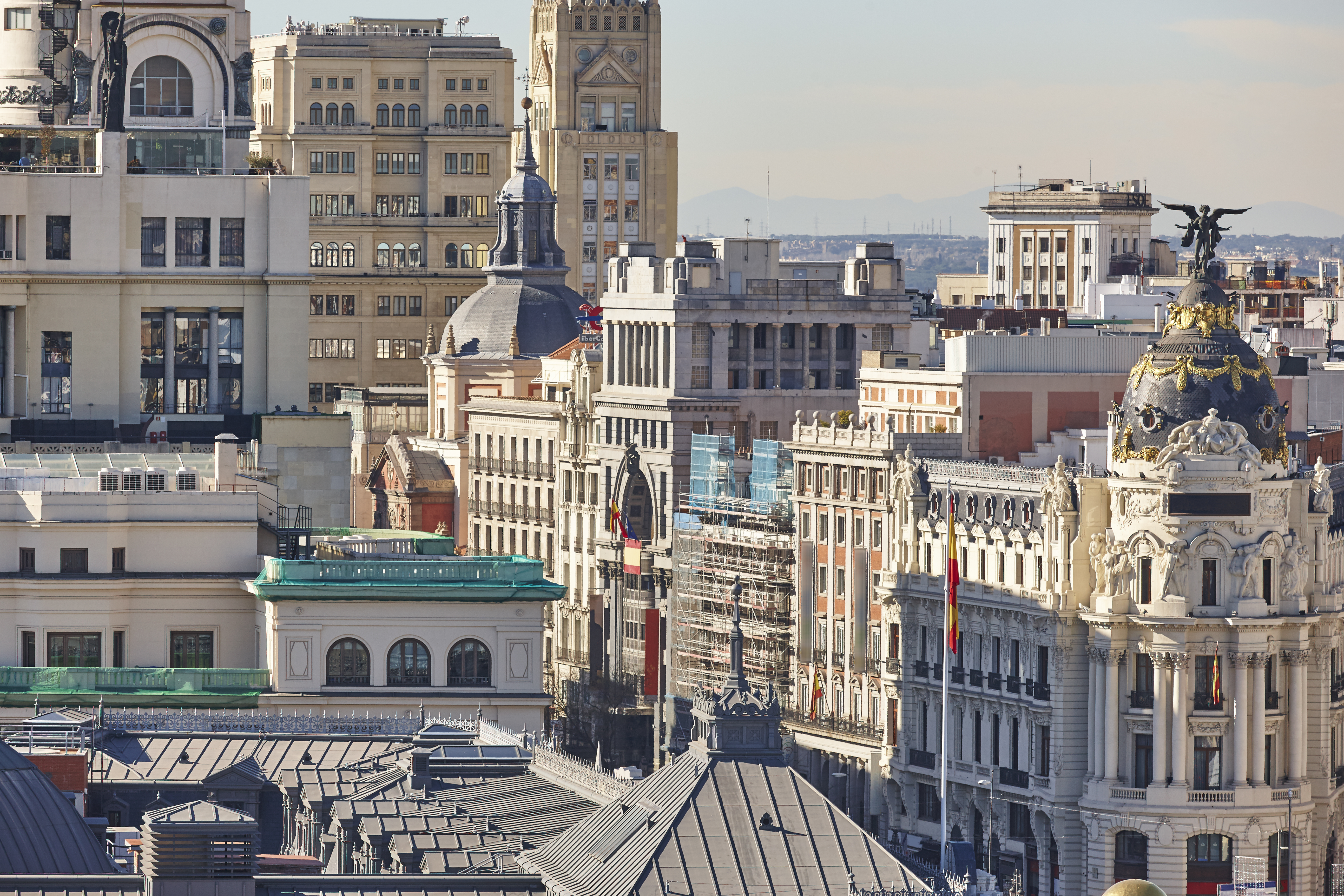 Aerial view of ornate historic buildings in central Madrid, Spain, under clear skies