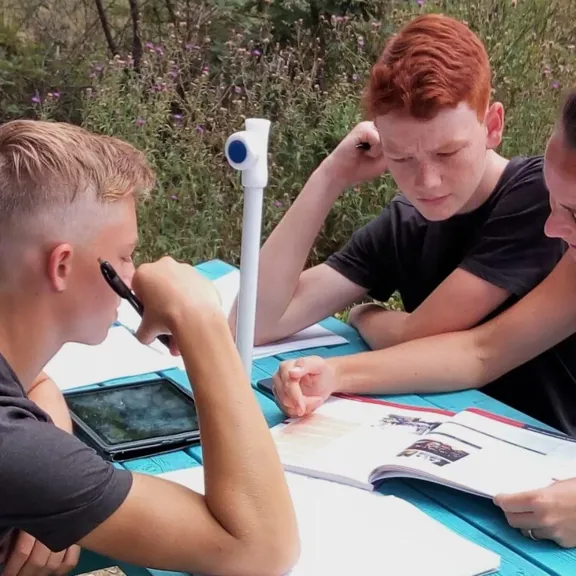 Karren helping Aiden, and Sebastian.