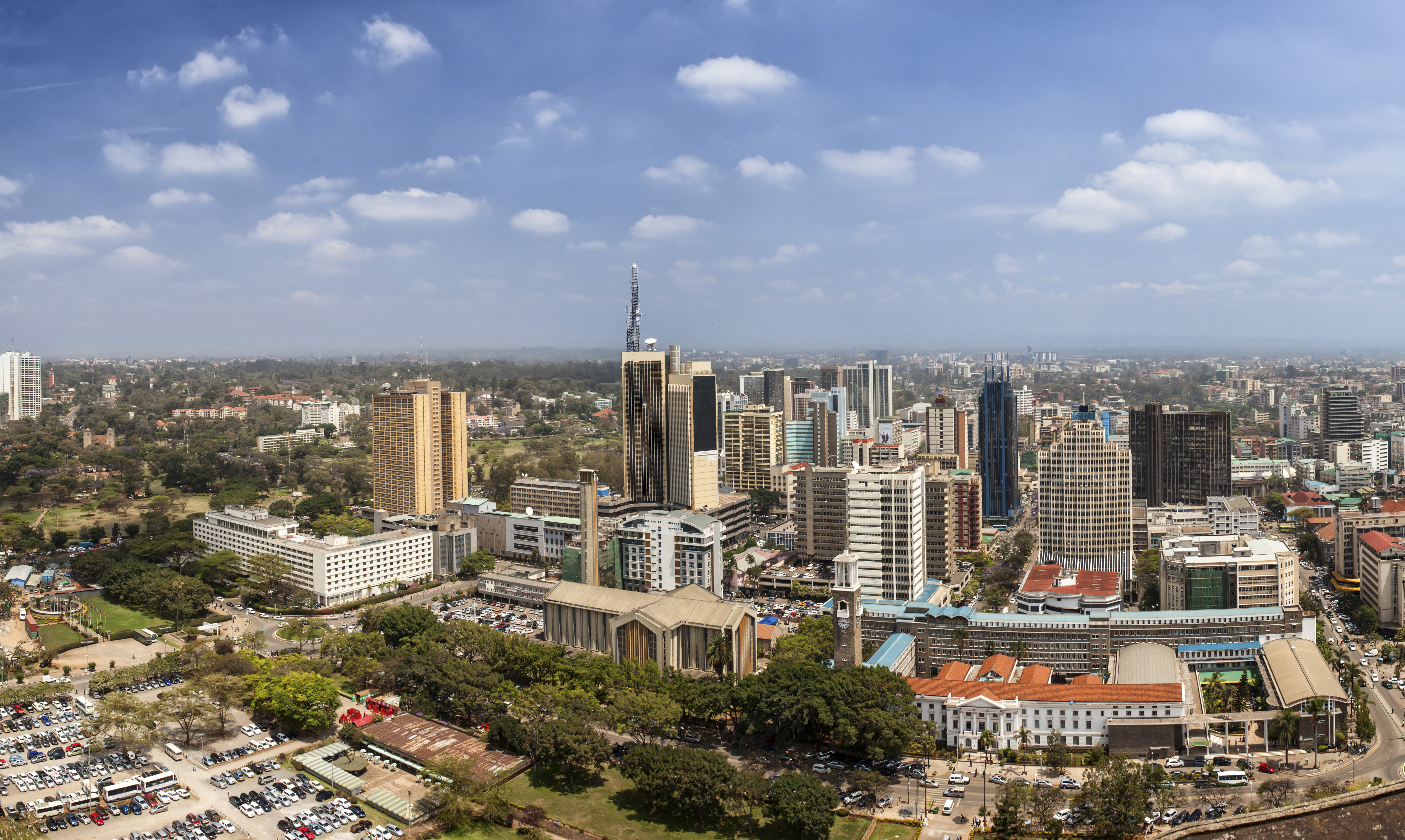 Nairobi cityscape with high-rise buildings, green spaces and blue skies
