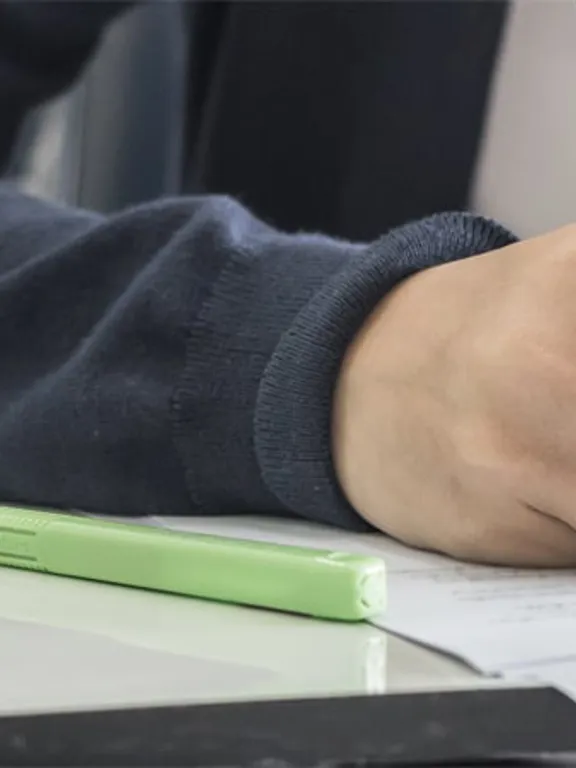 Homeschooling college student taking an exam at an exam centre.