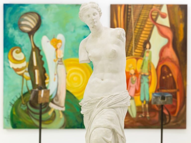 An old Greek statue housed in a modern museum. 