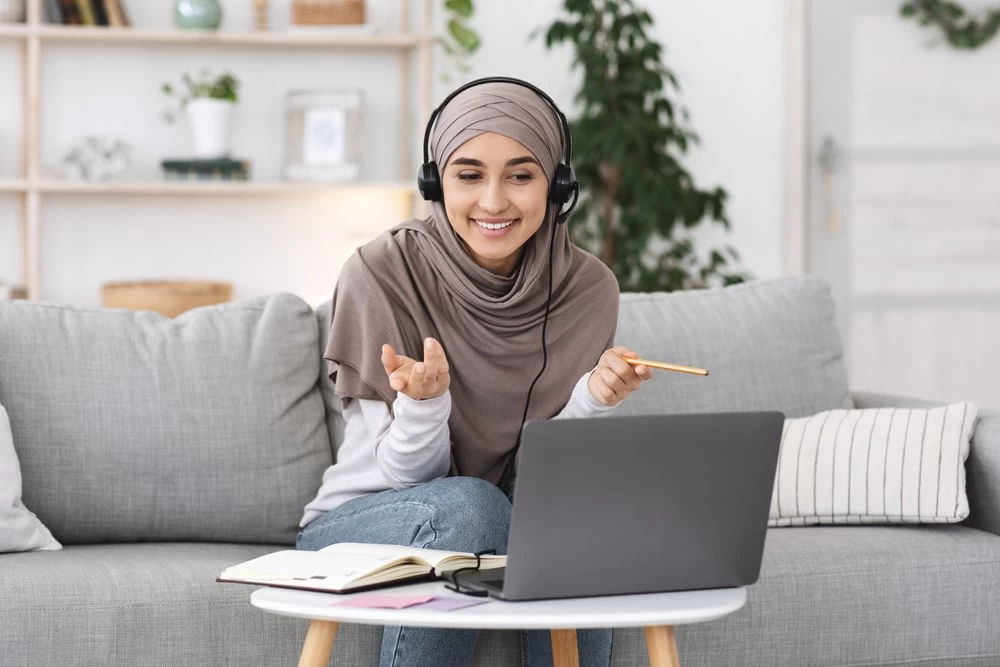 GCSE Level student using her laptop for a video call. 